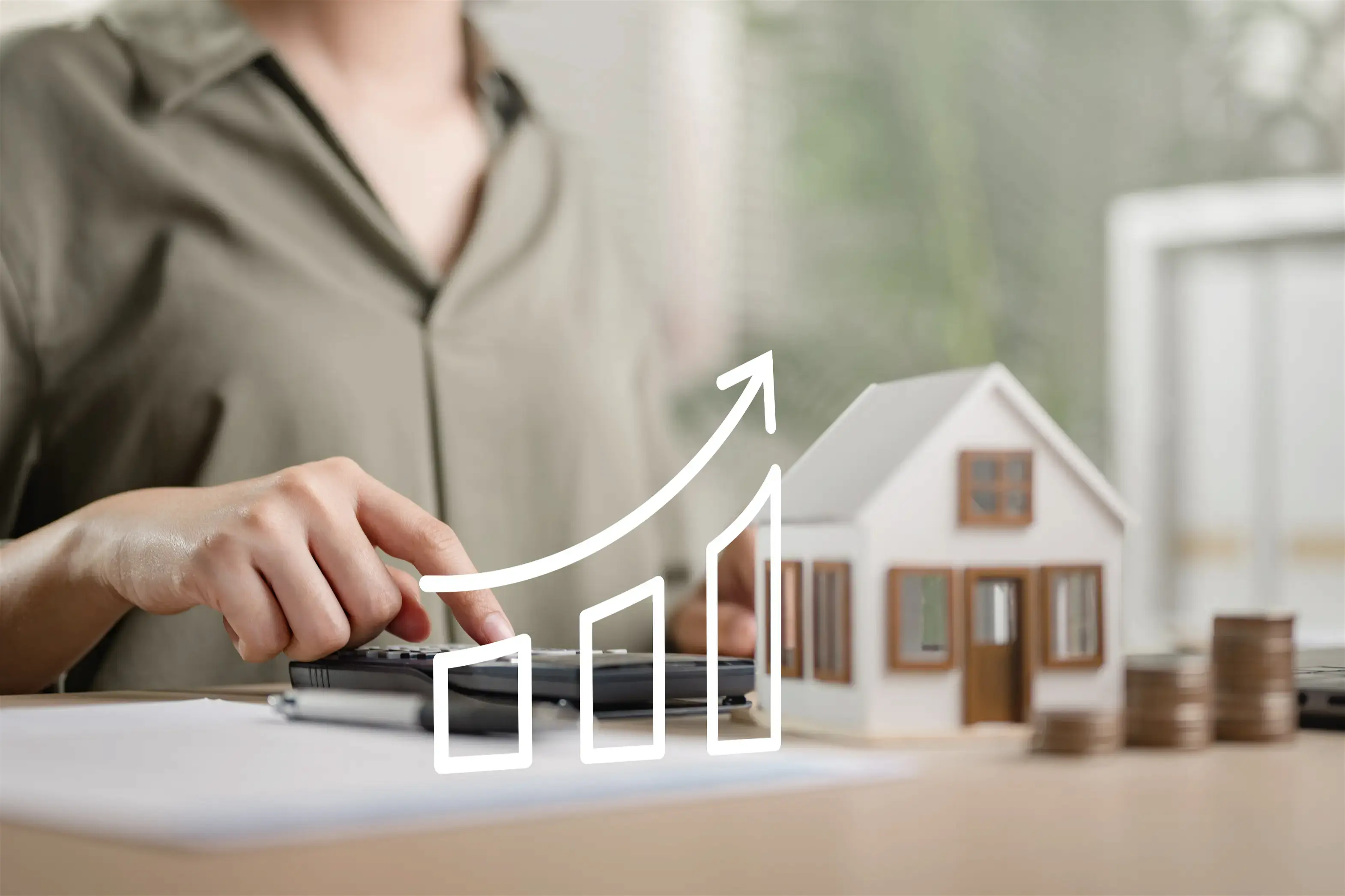 On aperçoit une personne qui fait des calculs, une maison miniature et un schéma